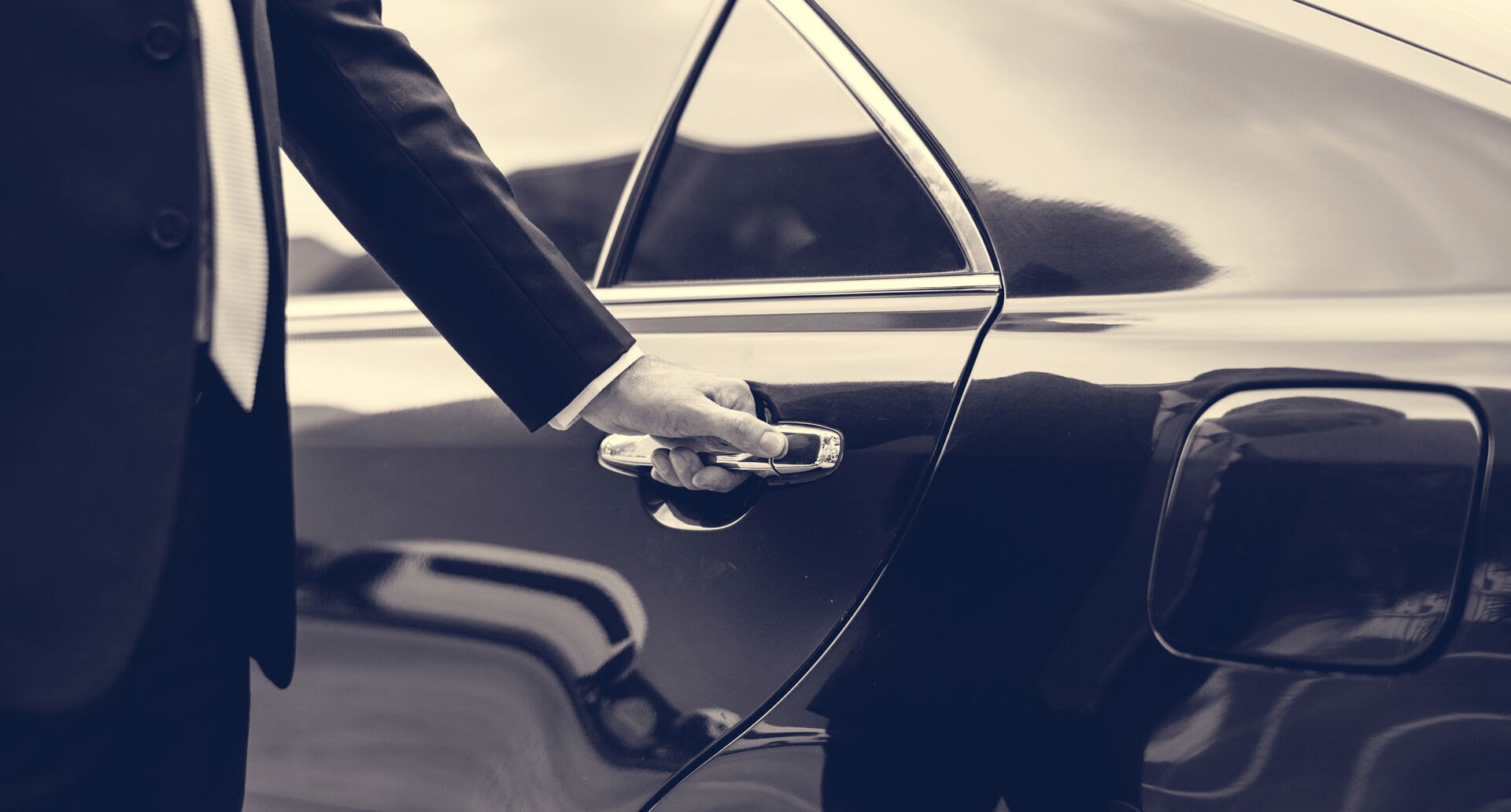 Chauffeur opening a car door